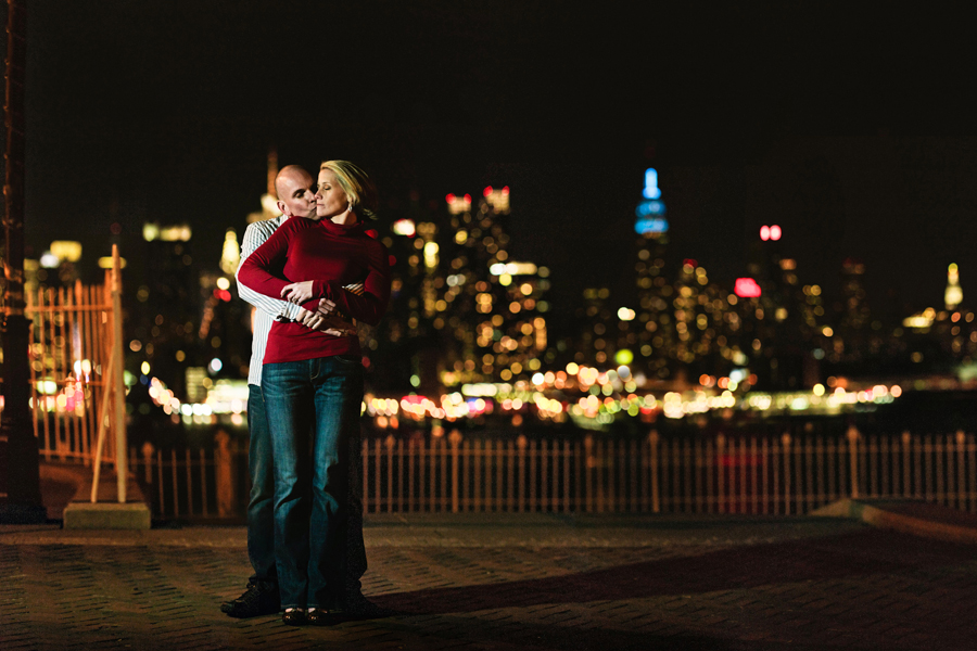 Couple poses in front of NYC skyling during their engagement photo session with their monmouth county nj wedding photographers markow photography