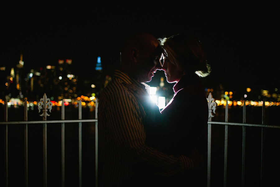 Couple poses in front of NYC skyling during their engagement photo session with their monmouth county nj wedding photographers markow photography