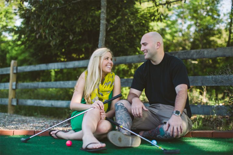 couple plays mini golf during engagement session with monmouth county wedding photographers