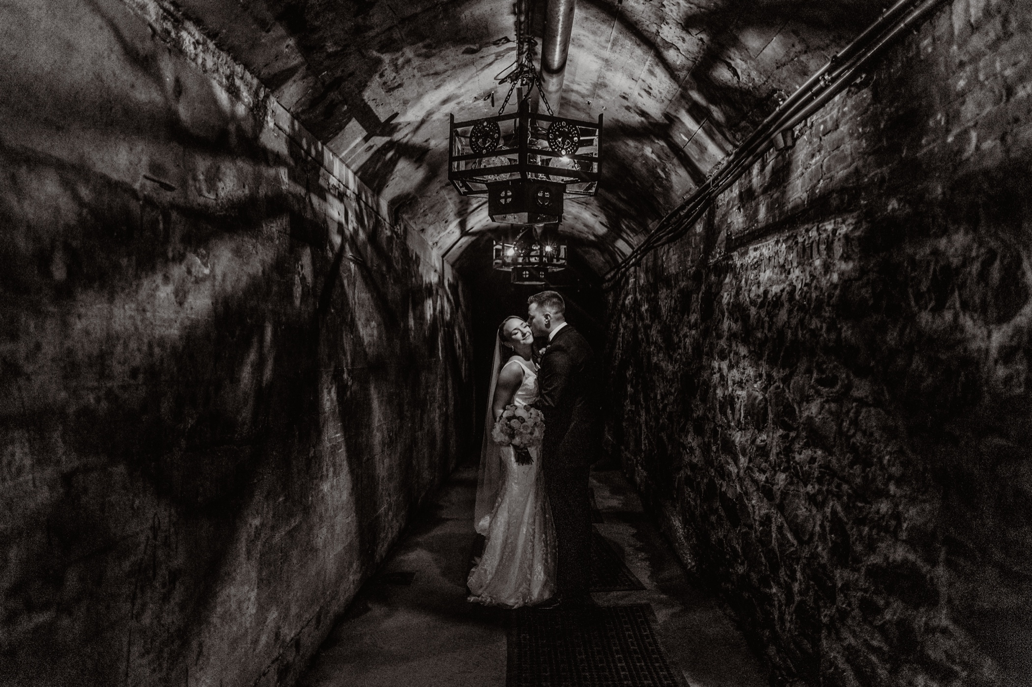 Black and White Photo of Bride and Groom in Wine Cellar